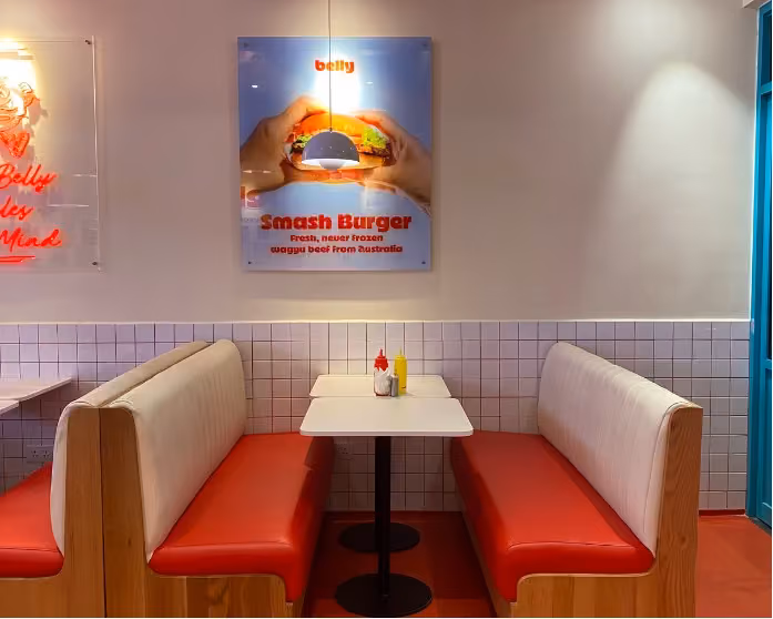 American style table and bench seat in dinning room of Belly burger